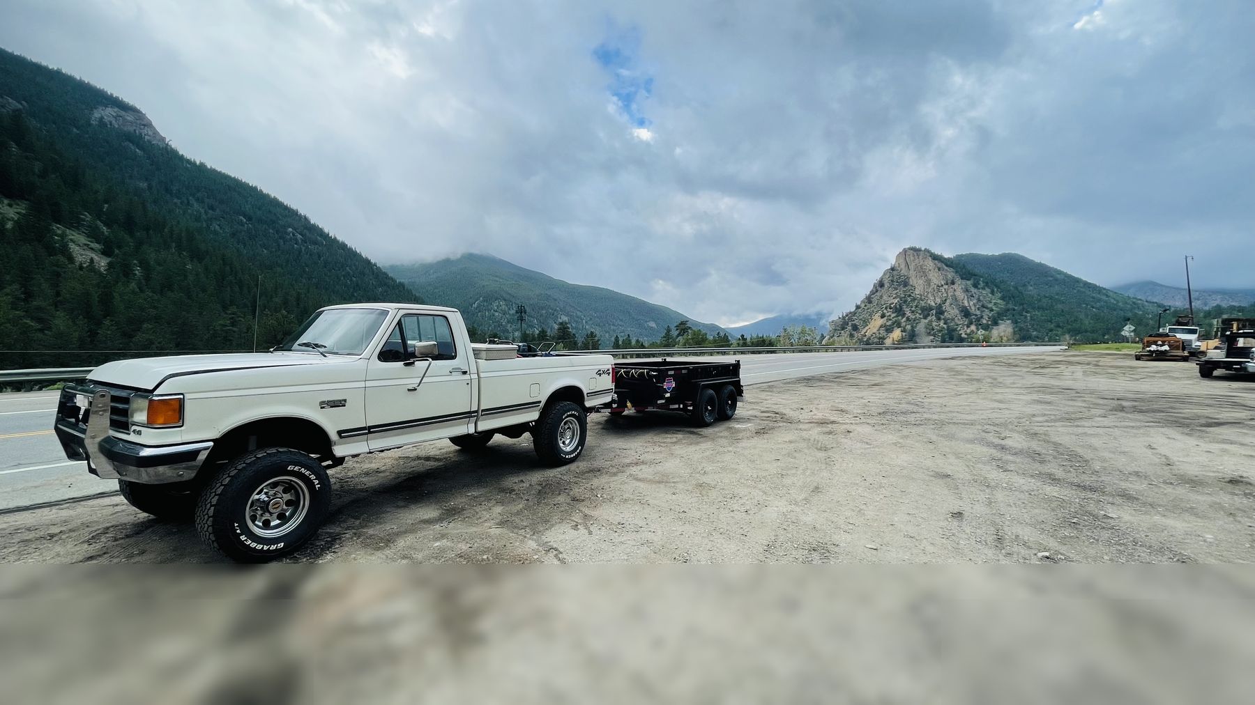 Boulder Tree Surgeon truck and trailer with the foothills behind, Boulder, CO