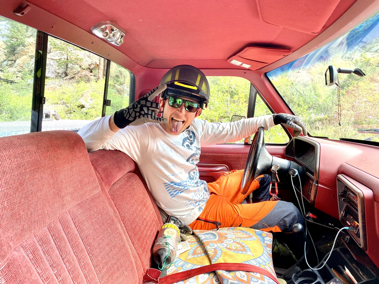 Arborist in full climbing PPE — helmet, chaps, harness — ready for the job