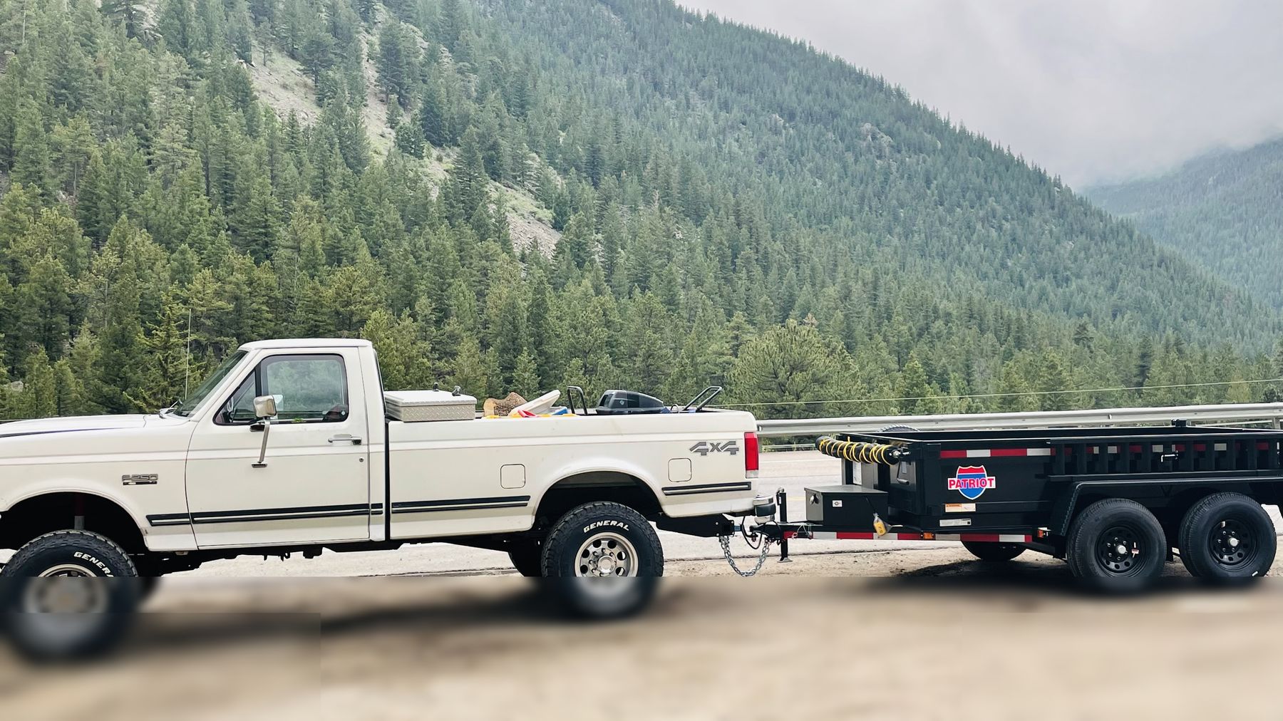 Tree service truck and trailer in the canyon near Lyons, CO